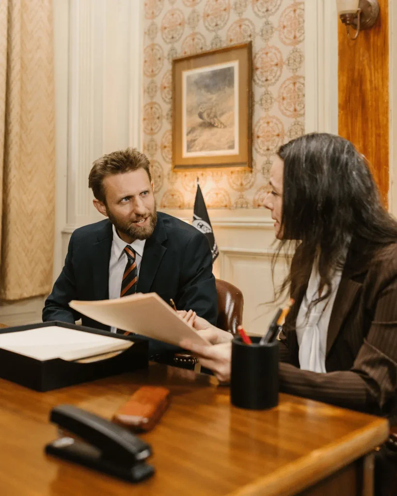 Law firm attorney meeting with a client in a professional office